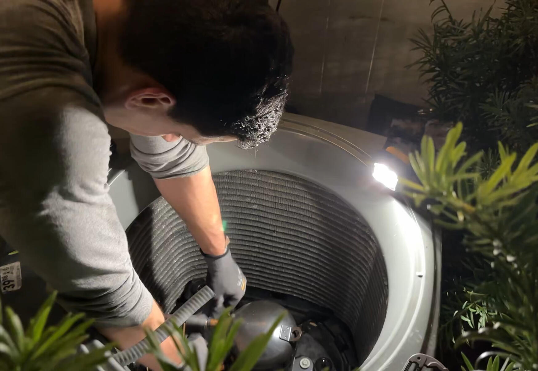 HVAC Technician making a repair Repairing the Condenser Unit